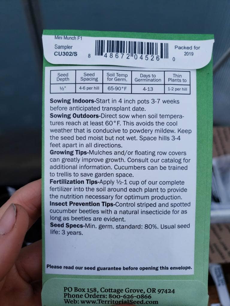 The back of a seed packet, which should include planting tips, depth for sowing seeds, ideal temperature ranges, and important dates for that particular vegetable, flower, or garden herb variety. 